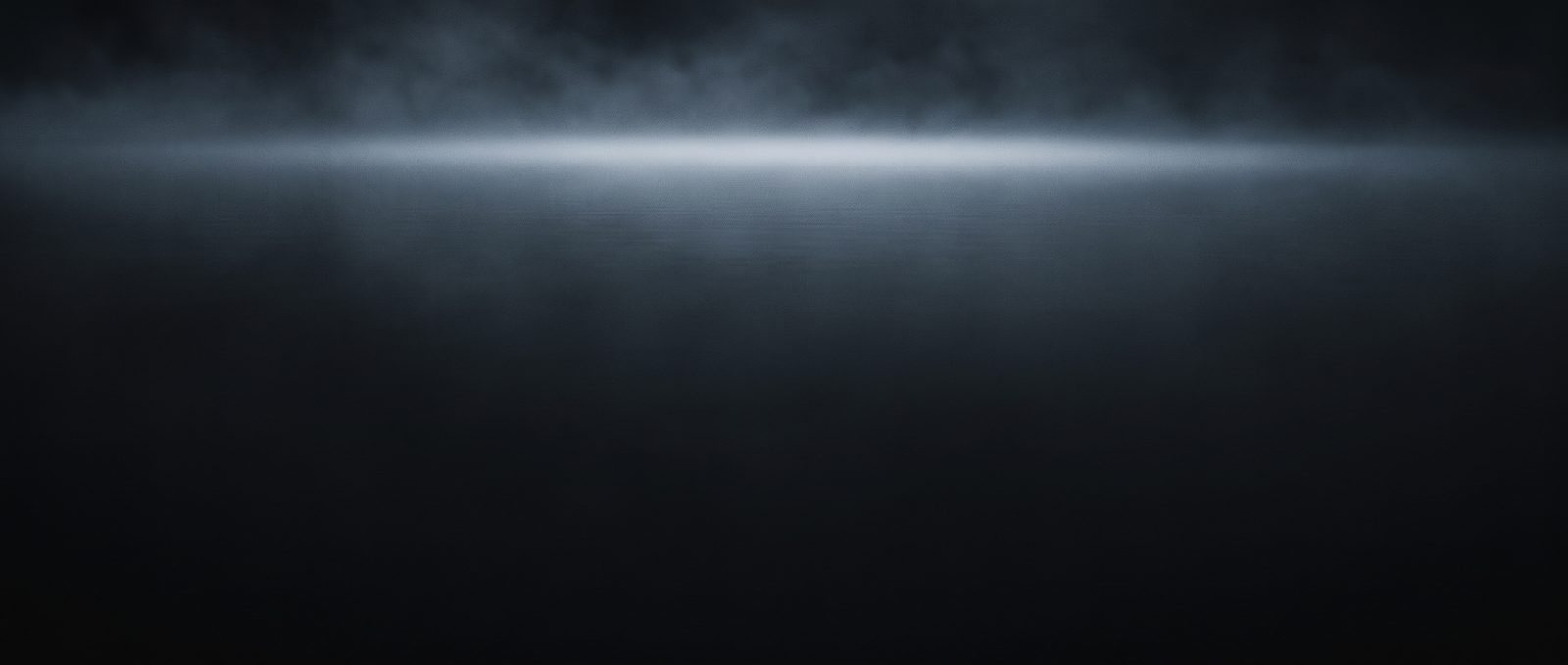Mist rising from cold still water in low light